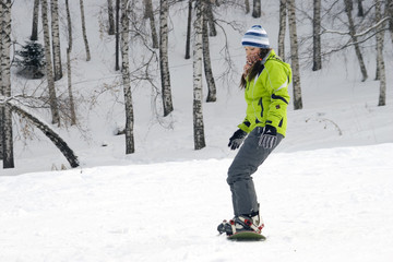 Fototapeta na wymiar A health lifestyle image of young beautiful snowboarder girl