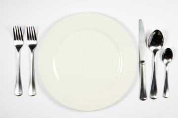A table setting for a formal dinner against white background