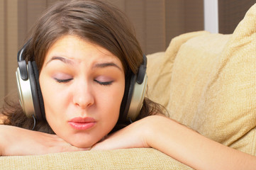 Young Girl enjoys listening music in headphones