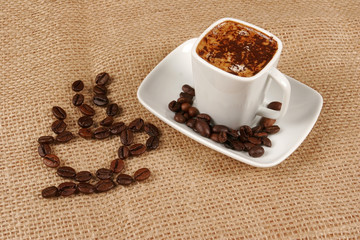 Coffee cup made from coffee beans on a burlap