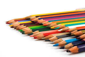 Assortment of coloured pencils on white background