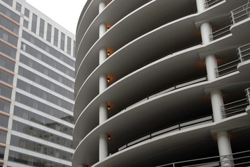 Curved concrete parking structure & generic office building