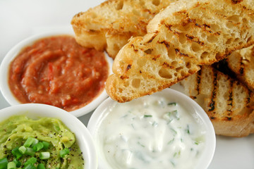Delicious and colorful trio of dips with grilled Turkish bread.
