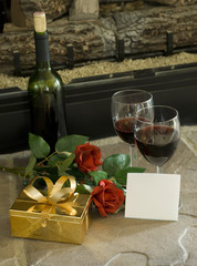 wine glasses and roses with gift and blank card
