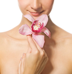 Girl's face with orchid flower isolated on white background