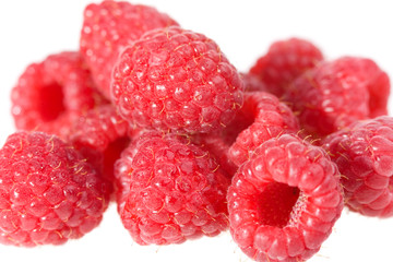 pile of raspberries with water drops macro