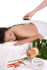 Obraz na płótnie Canvas Beautiful woman undergoing a massage treatment with hotstones