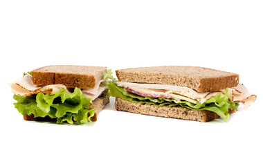 A fresh deli sandwich with lots of meat and green lettuce