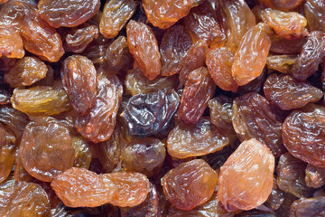 closeup on many sweet dry raisins, food background