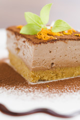 Mocca cheese cake with jam on coffee table (very shallow dof)