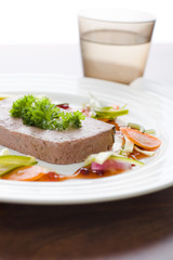 Gourmet game Pâté with vegetables and jam on the table
