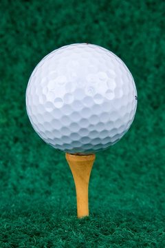 White Golf Ball On Natural Wood Tee