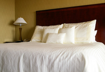 Bed with white pillows and sheets