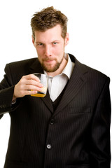 Young man in suit with an orange drink