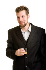 Young man in suit with an orange drink