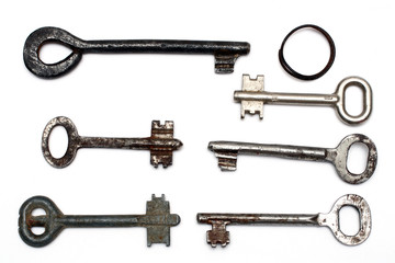 six old rusty keys and keyring isolated on white