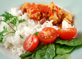 Chicken lentil stew with rice and a fresh garden salad.