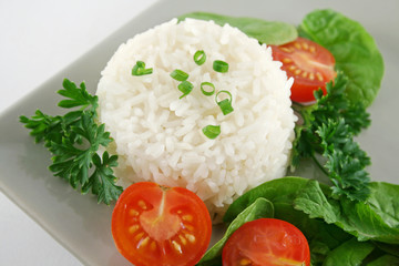 Steamed rice stack with a fresh garden salad.