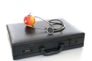 Business suitcase with apple and stethoscope