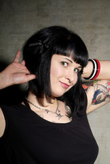 a woman with black hair and tattoo