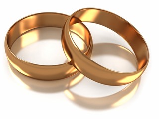 Golden wedding rings isolated on white reflective surface
