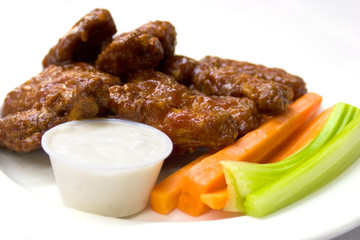 Spicy chicken wings served with carrots and celery
