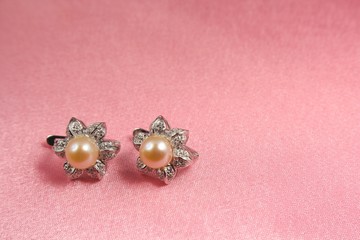 Jewelry pearl on pink background