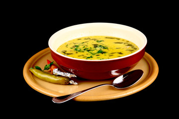 close up of a beef soup plate and two peppers