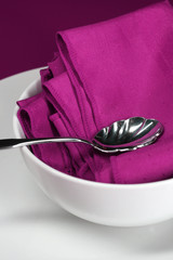 A close up of a modern table setting in purple