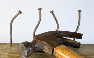Hammer and four bent nails