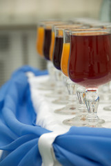 Glasses with vine snd juice in a row