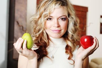 beautiful woman is holding fruits in her hands