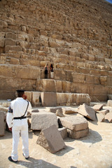 a policeman watching two women in kefren pyramid