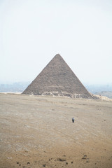 two men walking towards micerinos pyramid in el cairo