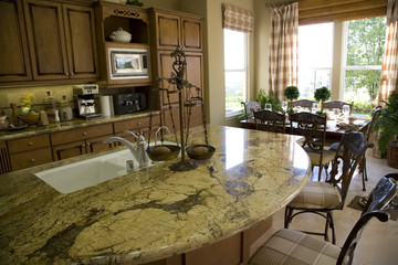 Luxury home kitchen with a granite top island. 