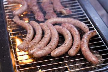 Barbecue sausage on grill with flame
