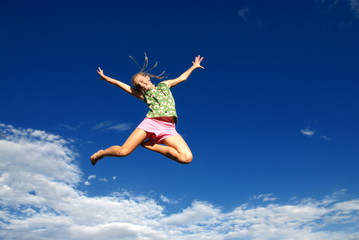 Happy jumping girl and sky