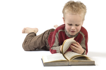 5 year old reading a book, isolated on white. 