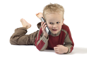 Little boy on the phone, calling his grandpa. Isolated on white.