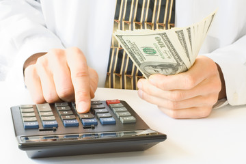 calculator and money in hand
