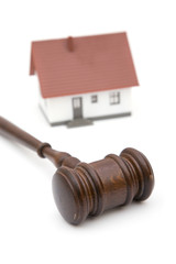 concept for real estate laws with a house and gavel on white
