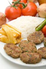 meat balls with french fries and rice on white