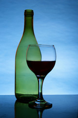 Still-life with glass and bottle of red wine