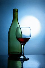 Still life with bottle and glass of red wine