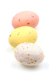 Speckled multicolored chocolate EASTER eggs in row