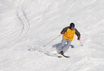 Fototapeta na wymiar skier man moving down in yellow suit