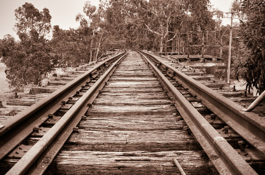 brown sepia image of looking along the tracks 