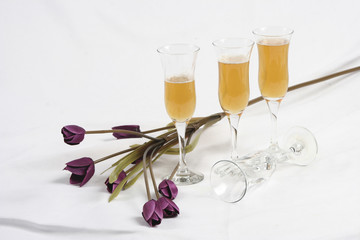 Artificial flowers and four wine glasses