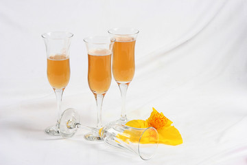 Four wine glasses and petals