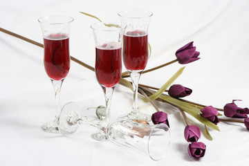 Artificial flowers and four wine glass